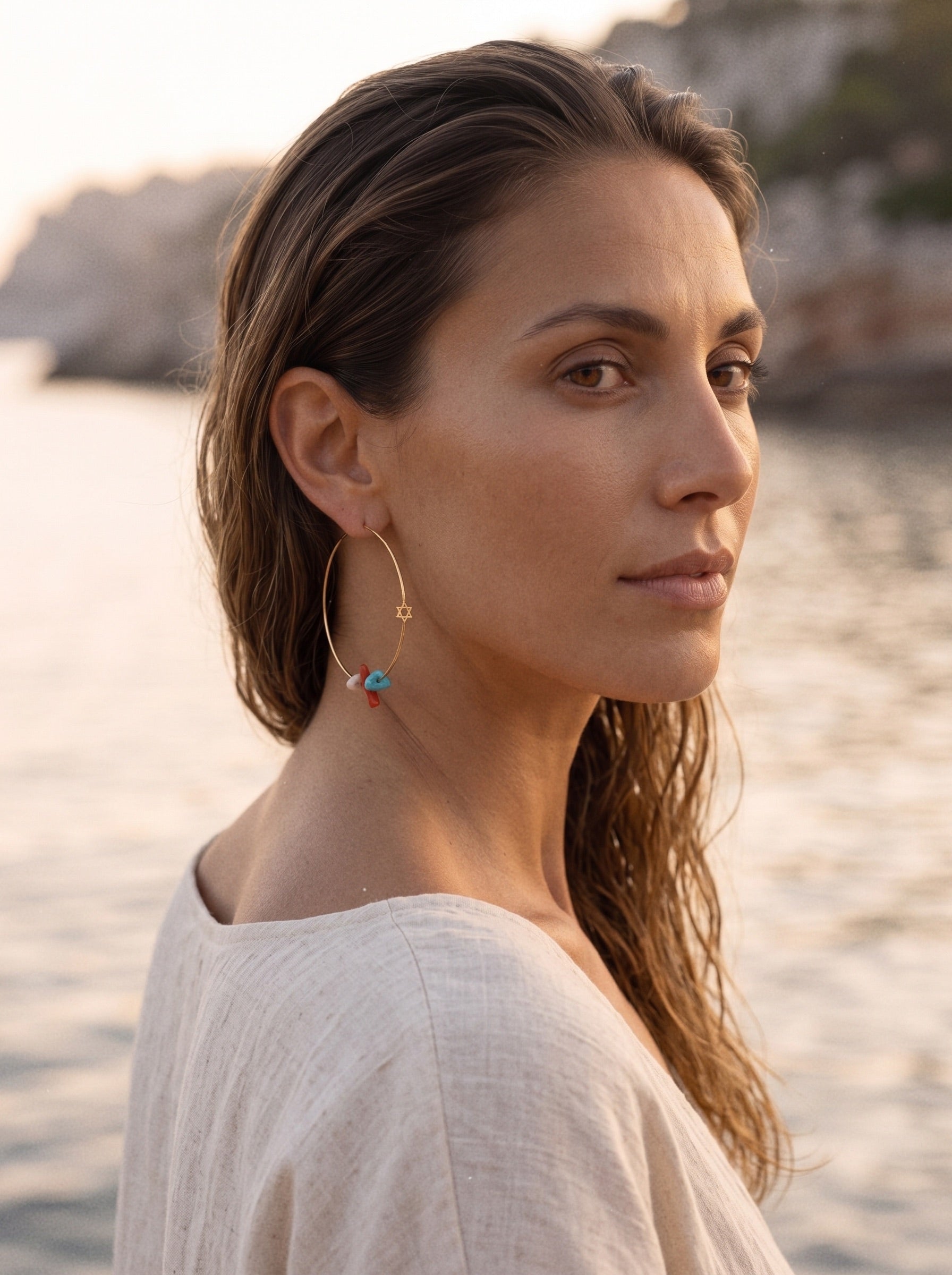 Yaël gold hoop earrings worn, catching the light — Oriya Jewels