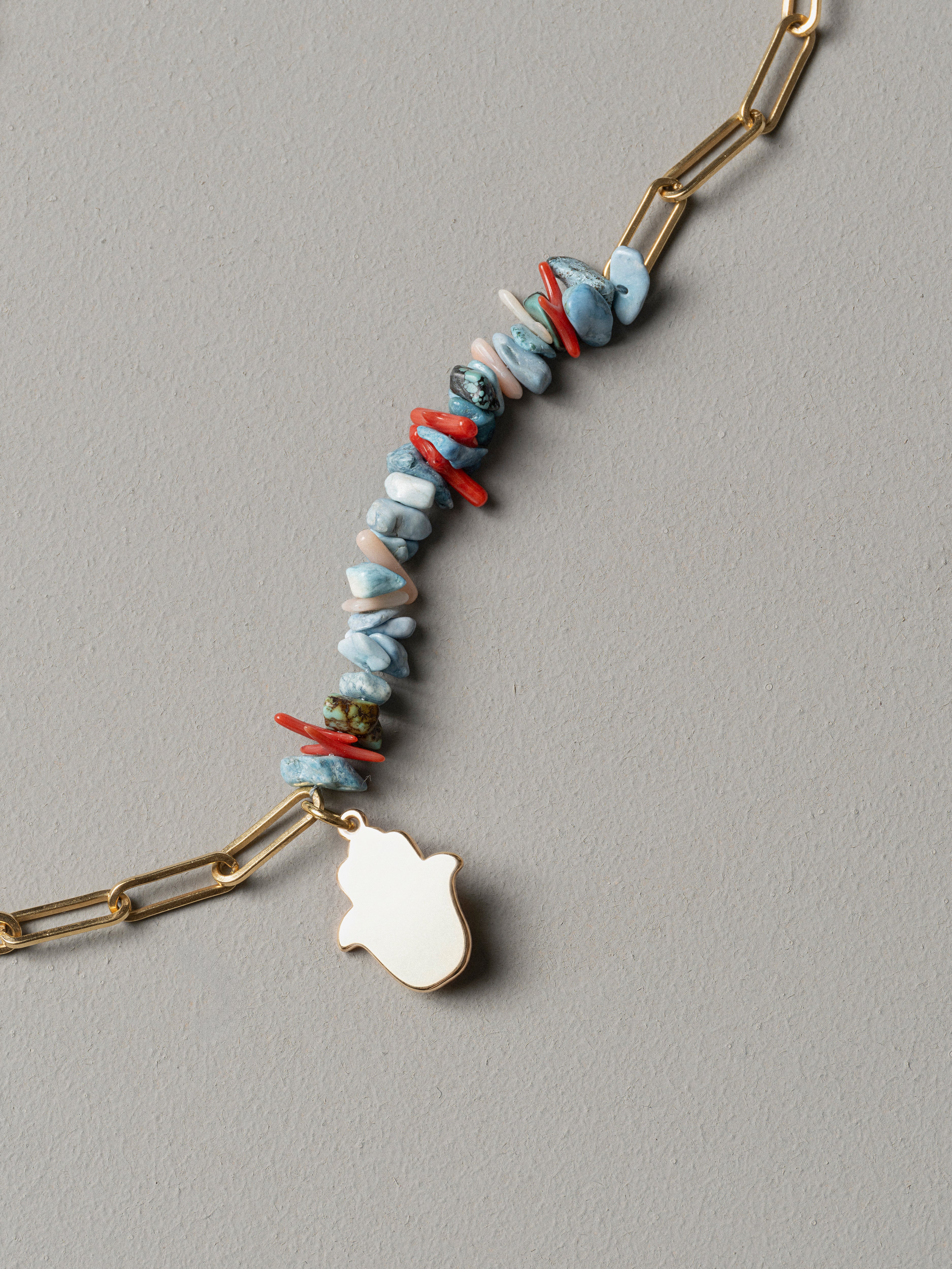 Deborah gold paperclip necklace worn, layered against summer linen — Oriya Jewels