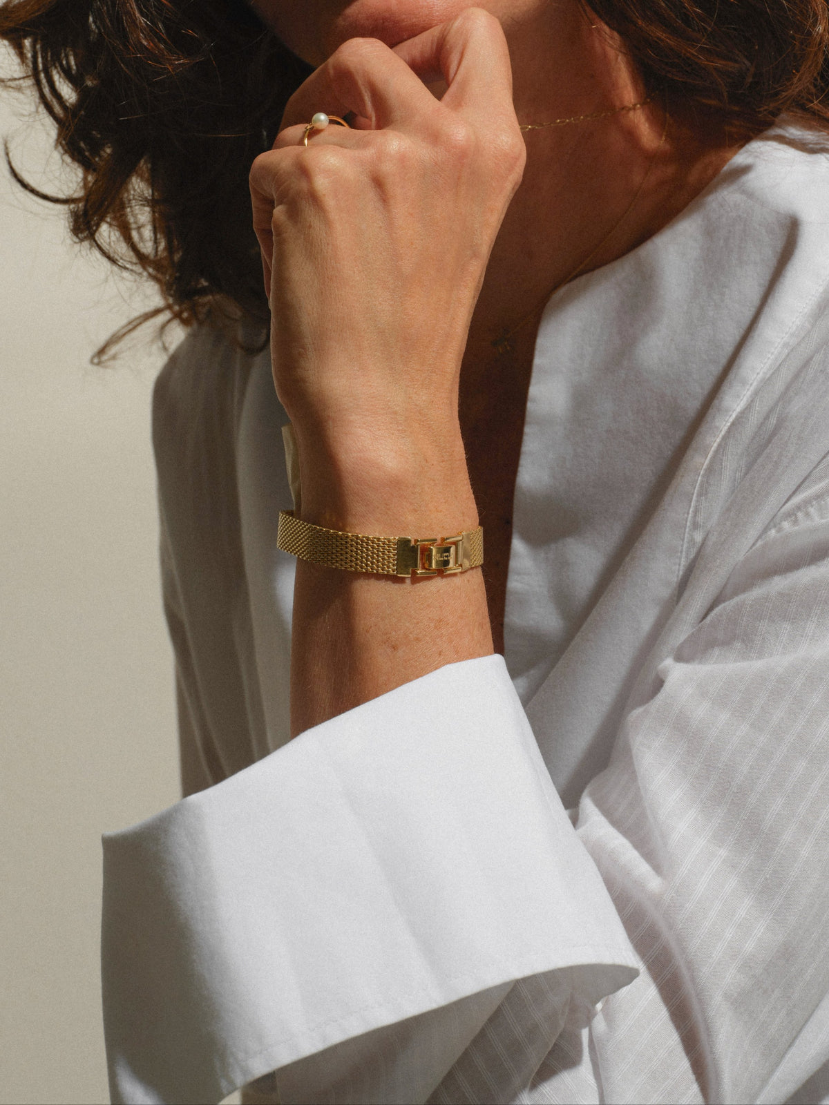 Ahava Bracelet worn — gold-plated brass mesh bracelet with engraved clasp on the wrist — Oriya Jewels